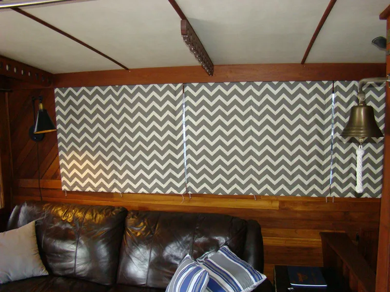 Slide: The Image of Interior of 1985 Jersey Dawn 40 boat with chevron-patterned blinds and leather seating. - 48