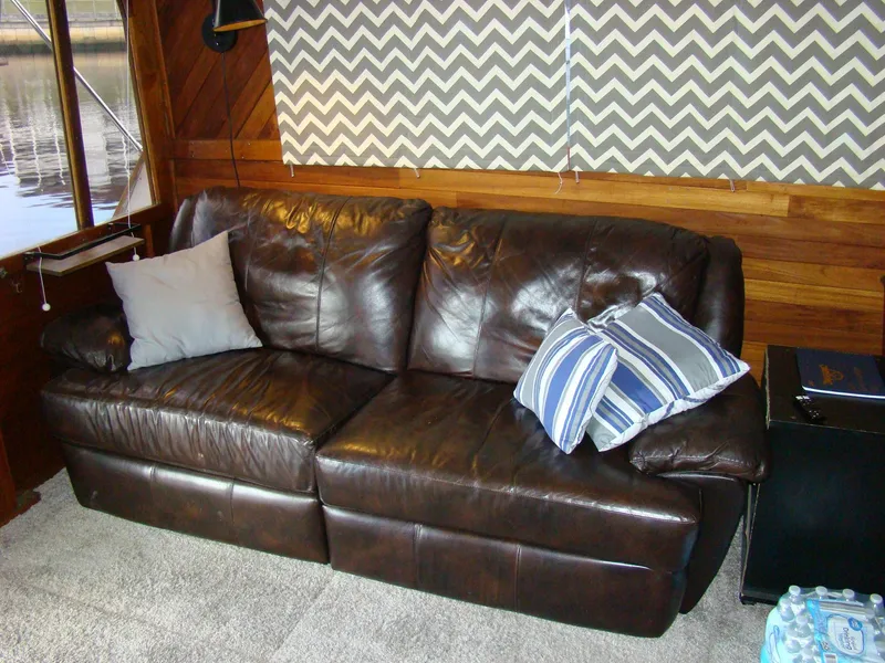 Slide: The Image of Brown leather sofa in a 1985 Jersey Dawn 40 boat interior. - 49