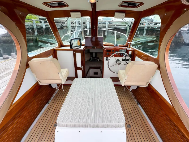 Slide: The Image of Interior of a 2004 Custom Pemaquid Beach 22 boat with wooden accents and seating. - 11