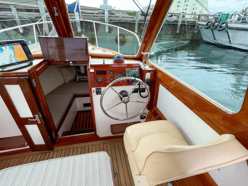 Slide: The Image of Interior of 2004 Custom Pemaquid Beach 22 boat with steering wheel and navigation equipment. - 12