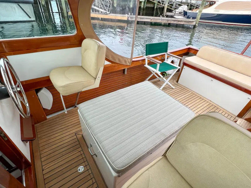 Slide: The Image of Interior of 2004 Custom Pemaquid Beach 22 boat with seating and wooden deck. - 18