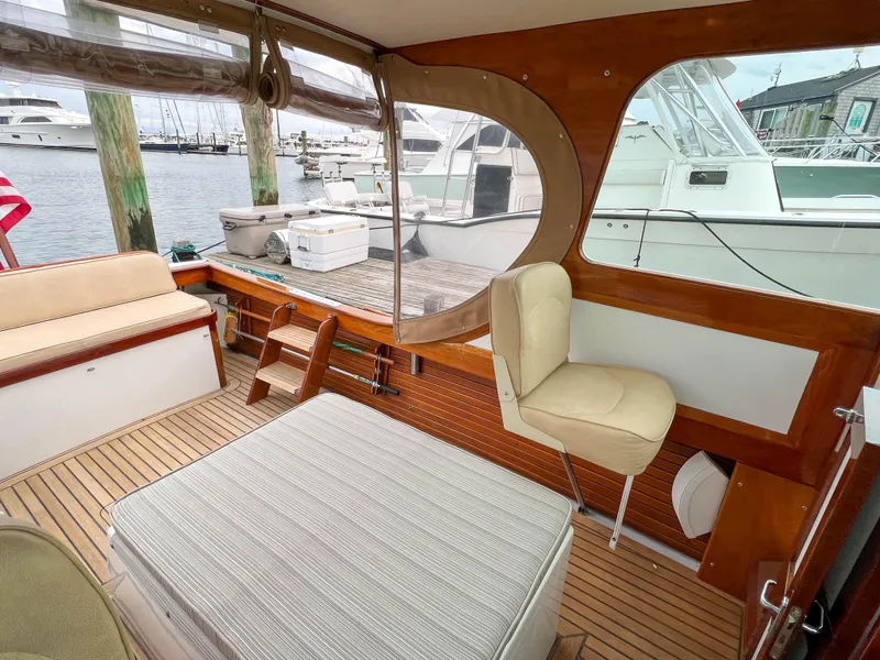 Slide: The Image of Interior of 2004 Custom Pemaquid Beach 22 boat with wooden finish and dock view. - 19