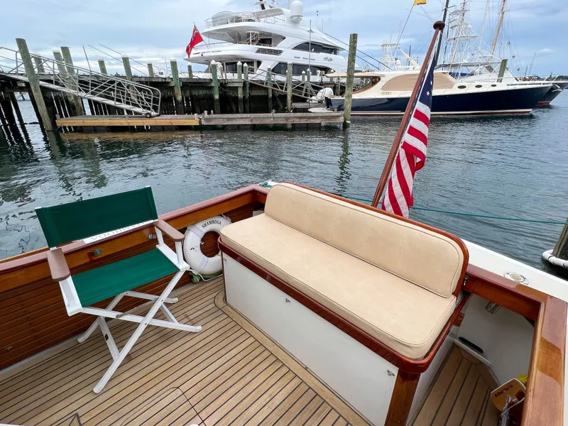 Slide: The Image of Custom 2004 Pemaquid Beach 22 boat with seating area, docked at marina. - 21