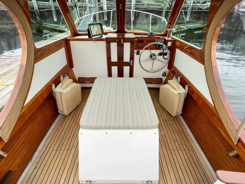 Slide: The Image of Interior of 2004 Custom Pemaquid Beach 22 boat with wooden trim and cushioned seating. - 24