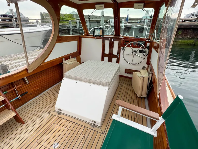 Slide: The Image of Interior of a 2004 Custom Pemaquid Beach 22 boat with wooden accents and seating. - 28