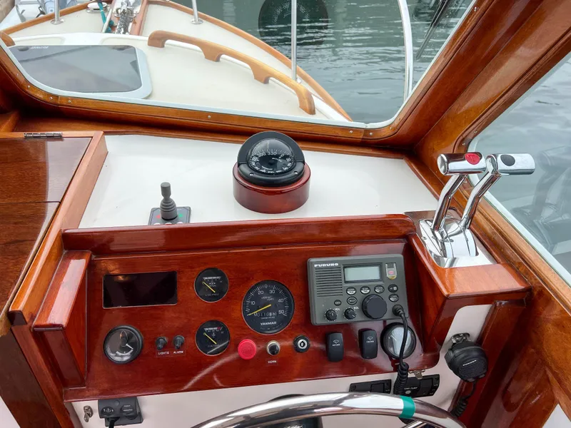 Slide: The Image of Helm of 2004 Custom Pemaquid Beach 22 boat with navigation instruments and controls. - 29