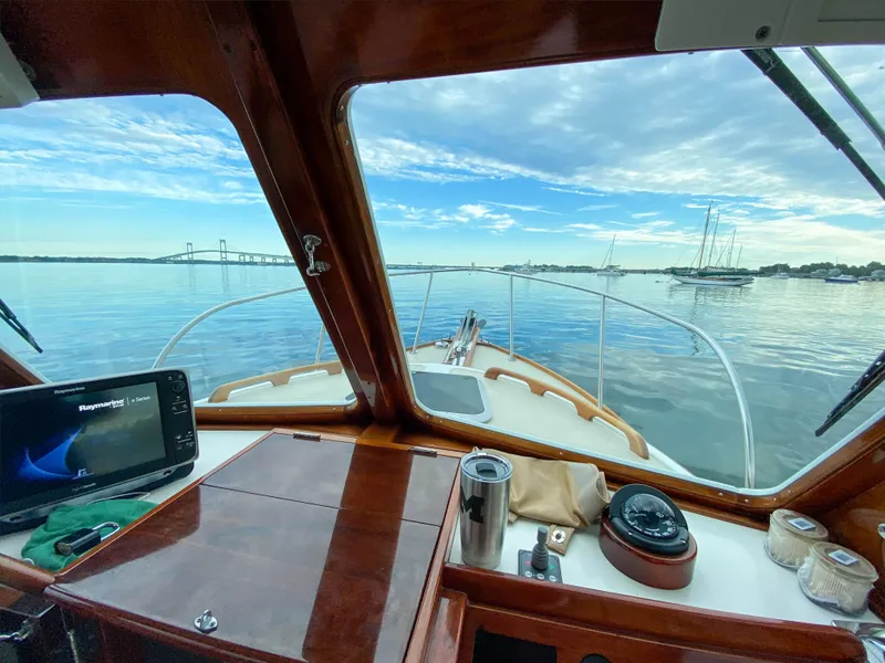 Slide: The Image of View from the helm of a 2004 Custom Pemaquid Beach 22 boat on calm waters. - 3