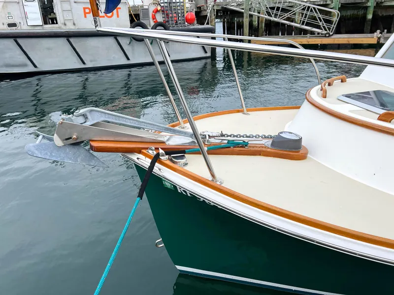 Slide: The Image of Custom 2004 Pemaquid Beach 22 boat docked, green hull, anchor on bow. - 30