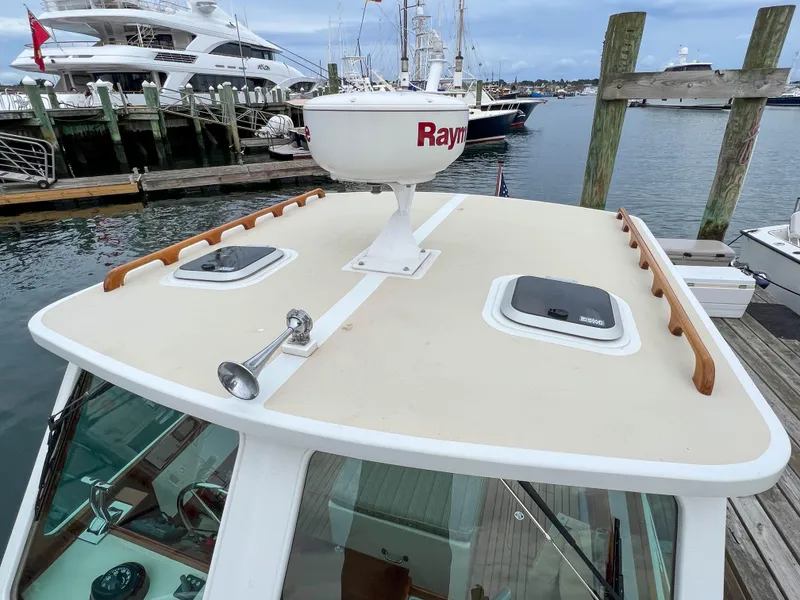 Slide: The Image of Custom 2004 Pemaquid Beach 22 boat docked, featuring Raymarine radar and deck hatches. - 32