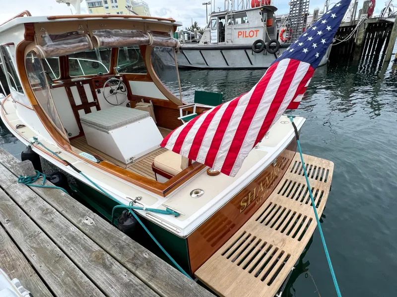 Slide: The Image of Custom 2004 Pemaquid Beach 22 boat docked with American flag. - 34
