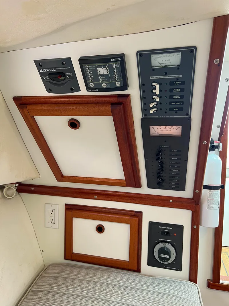Slide: The Image of Control panel and storage compartments inside a 2004 Custom Pemaquid Beach 22 boat. - 35