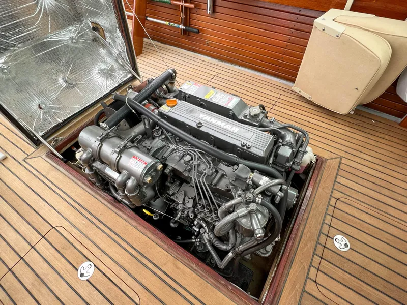 Slide: The Image of Engine compartment of a 2004 Custom Pemaquid Beach 22 boat with wooden deck. - 38