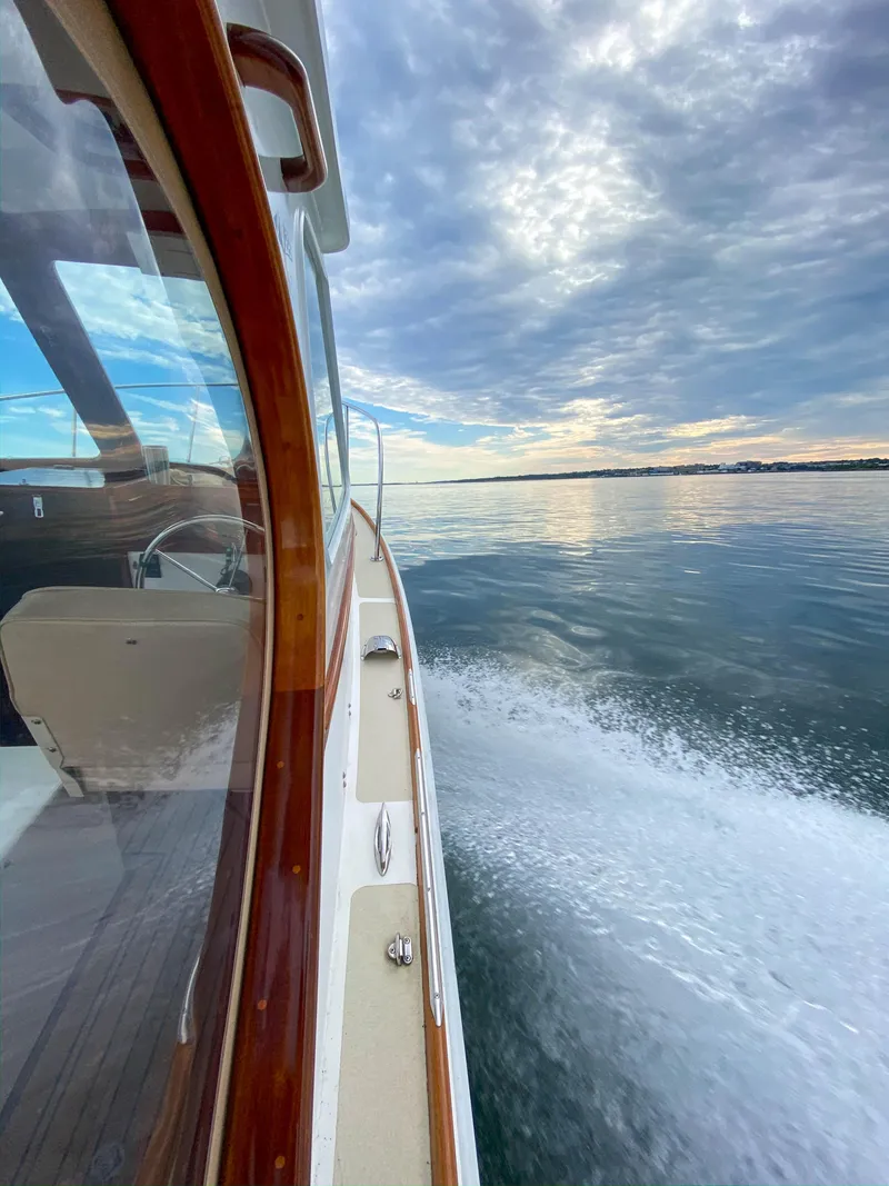 Slide: The Image of Custom 2004 Pemaquid Beach 22 boat cruising on calm waters under a cloudy sky. - 4