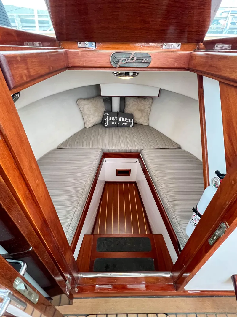 Slide: The Image of Cozy cabin interior of a 2004 Custom Pemaquid Beach 22 boat with wooden finishes. - 7