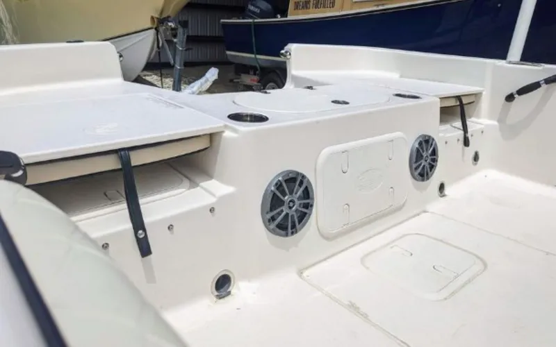Slide: The Image of 2022 Carolina Skiff 23 LS boat interior with storage compartments and speakers. - 2