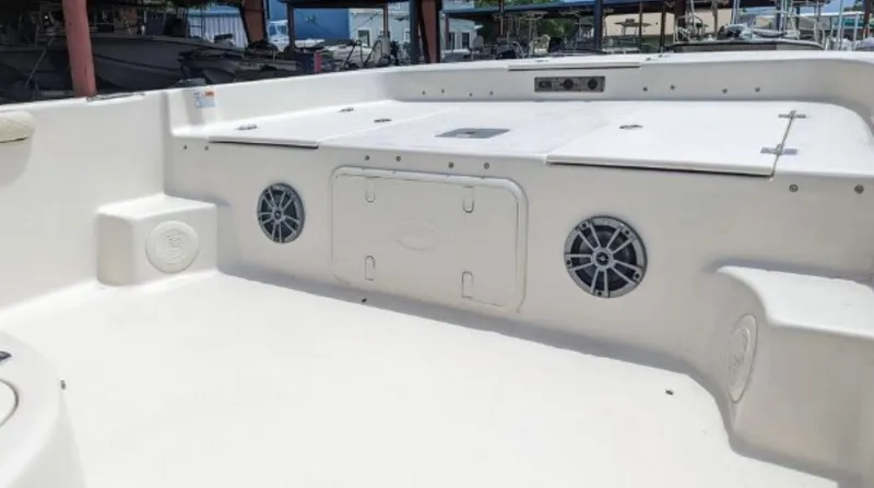 Slide: The Image of 2022 Carolina Skiff 23 LS boat interior with storage compartments and speakers. - 3