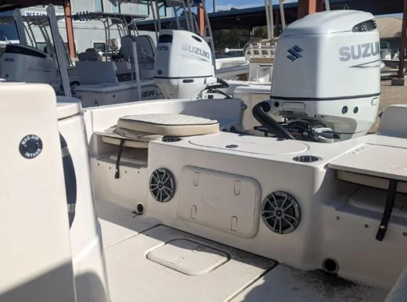 Slide: The Image of 2022 Carolina Skiff 23 LS boat with Suzuki outboard motor and seating area. - 7