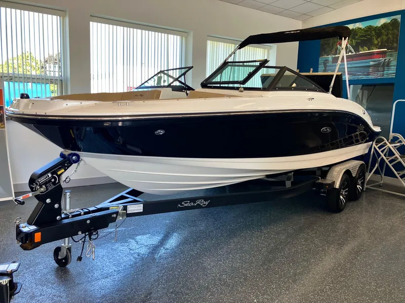 The Image of 2024 Sea Ray SPX 210 boat on trailer in showroom. - 0