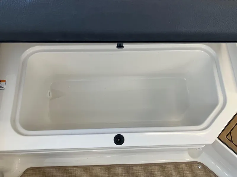 Slide: The Image of 2024 Sea Ray SPX 210 storage compartment, open and empty. - 12