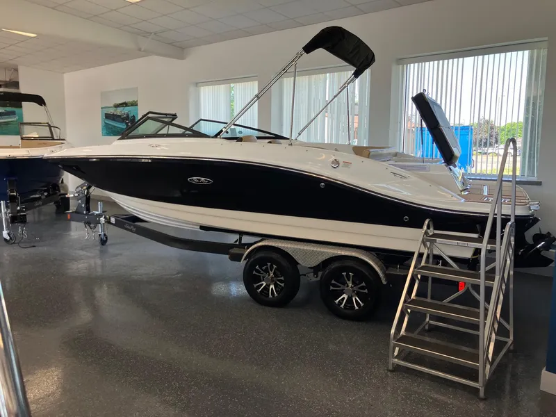 Slide: The Image of 2024 Sea Ray SPX 210 boat on display in showroom. - 2