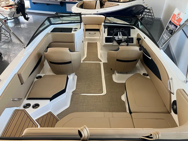 Slide: The Image of 2024 Sea Ray SPX 210 boat interior with tan seating and modern dashboard. - 5