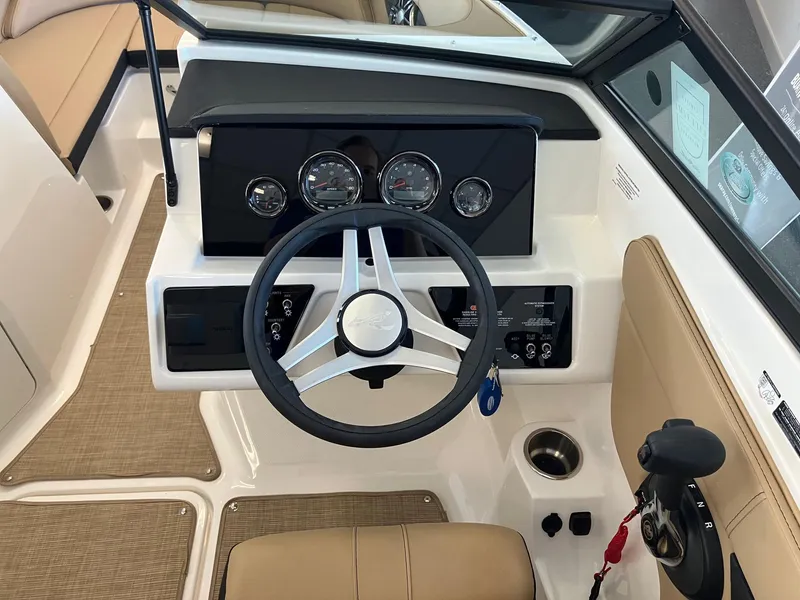 Slide: The Image of 2024 Sea Ray SPX 210 boat dashboard with steering wheel and control panel. - 6