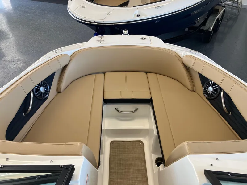 Slide: The Image of 2024 Sea Ray SPX 210 boat interior with tan seating and modern design. - 9