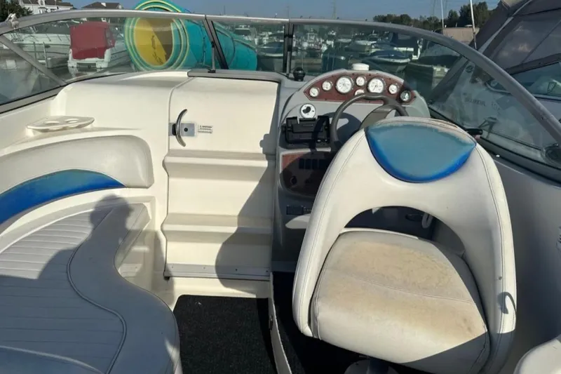 Slide: The Image of 2006 Bayliner 265 boat cockpit with steering wheel and seating. - 10