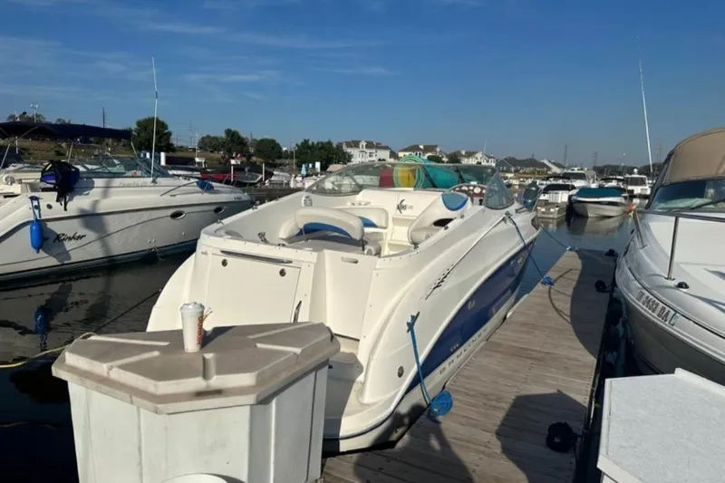 Slide: The Image of 2006 Bayliner 265 boat docked at a marina on a sunny day. - 4