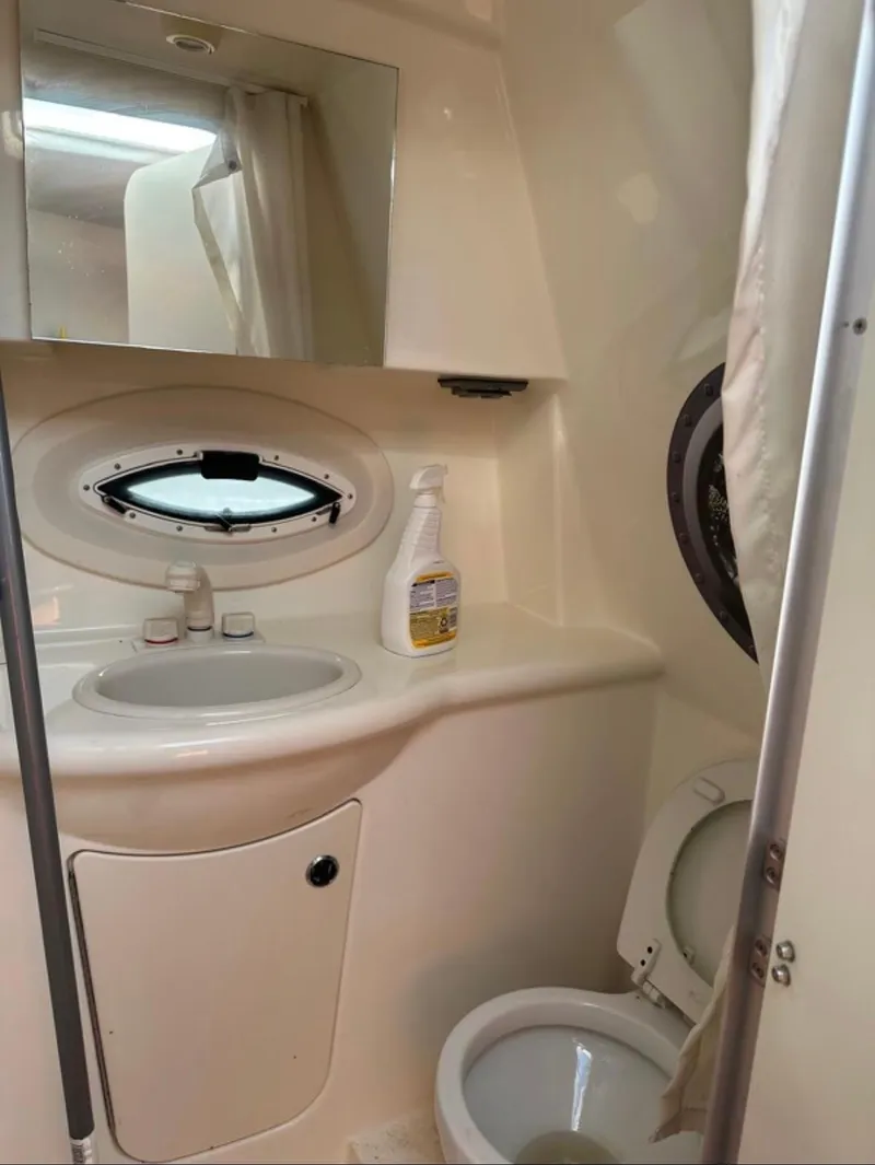Slide: The Image of 2006 Bayliner 265 boat bathroom with sink, mirror, and toilet. - 6
