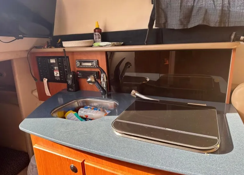 Slide: The Image of 2006 Bayliner 265 boat interior kitchen with sink and stove - 8