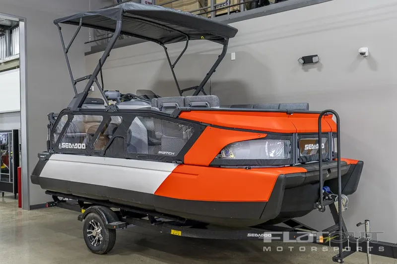 Slide: The Image of 2024 Sea-Doo SWITCH Cruise-18 230HP pontoon boat on trailer in showroom. - 3