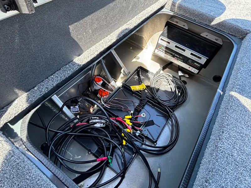 Slide: The Image of 2024 Ranger RT198P boat storage compartment with wiring and battery setup. - 12