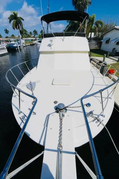 Slide: The Image of 1978 Hatteras 37 Convertible yacht docked in a marina. - 11