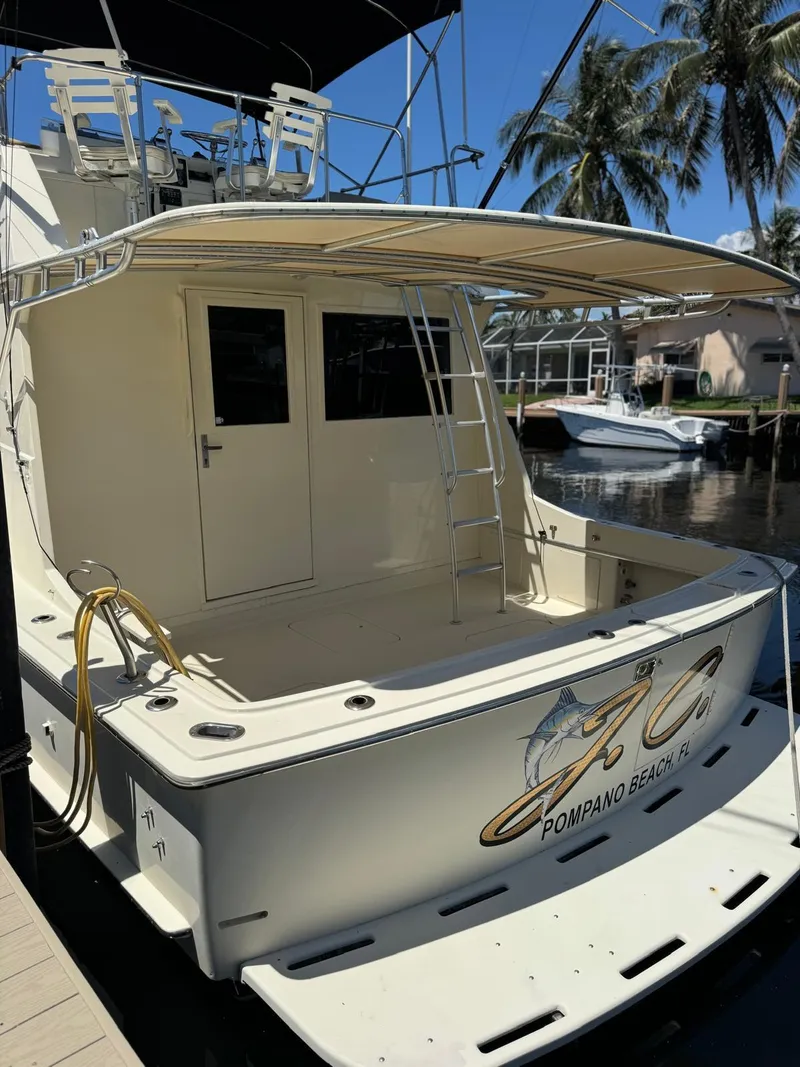 Slide: The Image of 1978 Hatteras 37 Convertible yacht docked, rear view with ladder and fishing gear. - 13