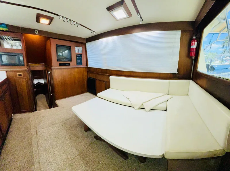 Slide: The Image of 1978 Hatteras 37 Convertible yacht interior with white leather seating and wooden cabinetry. - 4