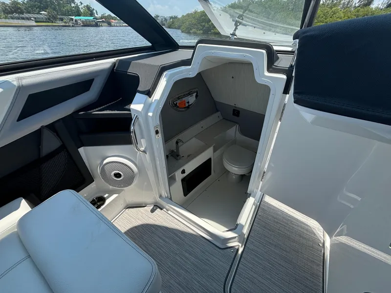 Slide: The Image of 2024 Cobalt R8 Outboard boat interior with open storage compartment and seating. - 11