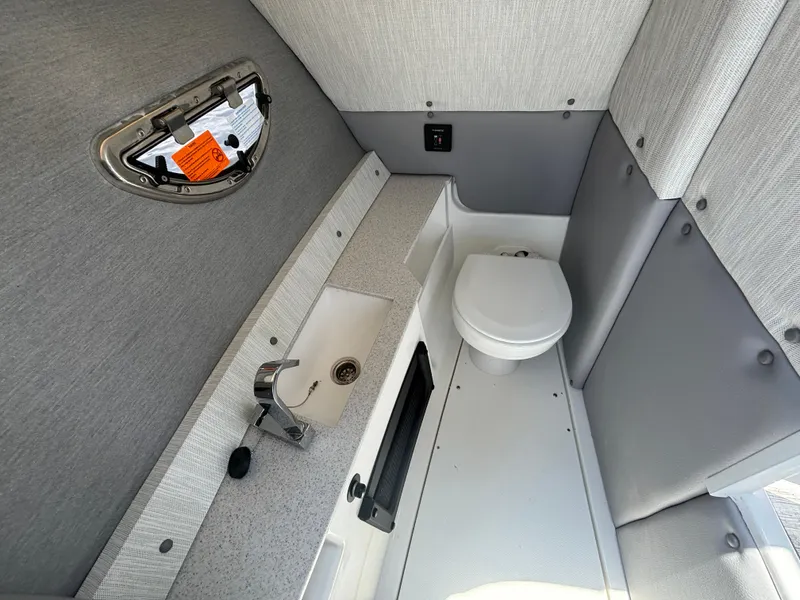 Slide: The Image of 2024 Cobalt R8 Outboard boat interior bathroom with sink and toilet. - 12