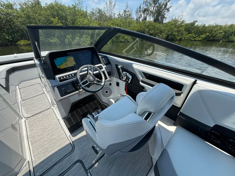 Slide: The Image of 2024 Cobalt R8 Outboard boat interior with modern dashboard and steering wheel. - 13