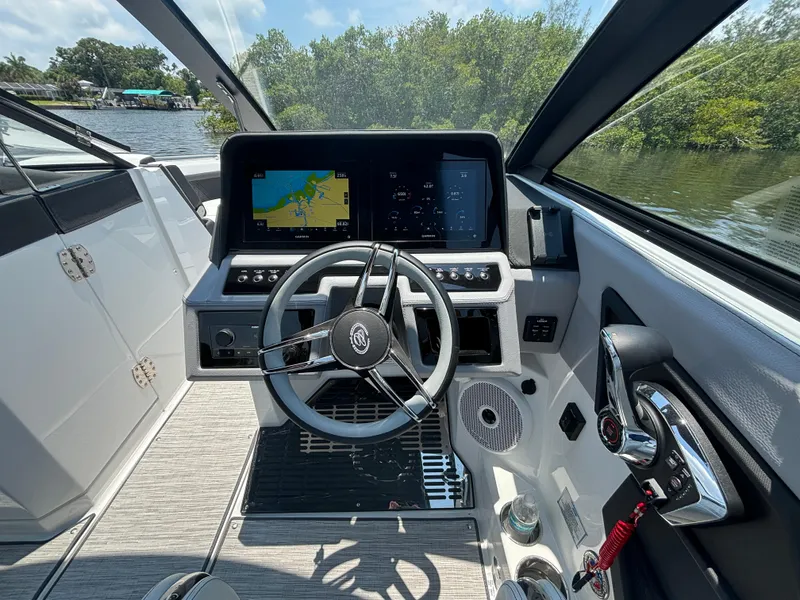 Slide: The Image of 2024 Cobalt R8 Outboard boat cockpit with modern navigation system and steering wheel. - 14