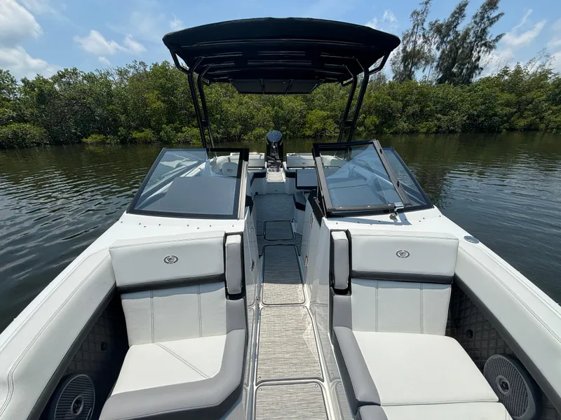 Slide: The Image of 2024 Cobalt R8 Outboard boat with spacious seating and sleek design on a calm waterway. - 15