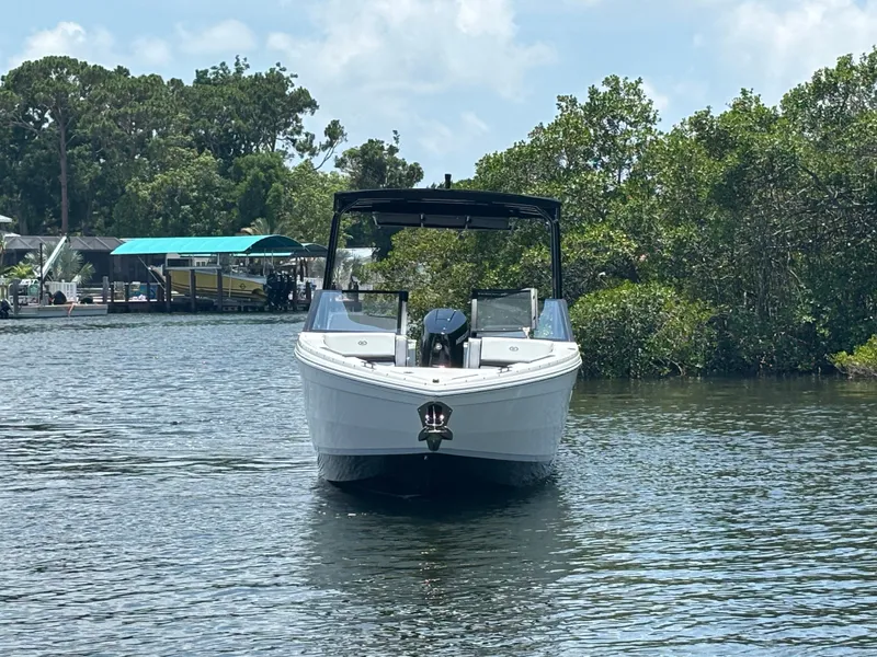 Slide: The Image of 2024 Cobalt R8 Outboard boat on a calm river. - 2