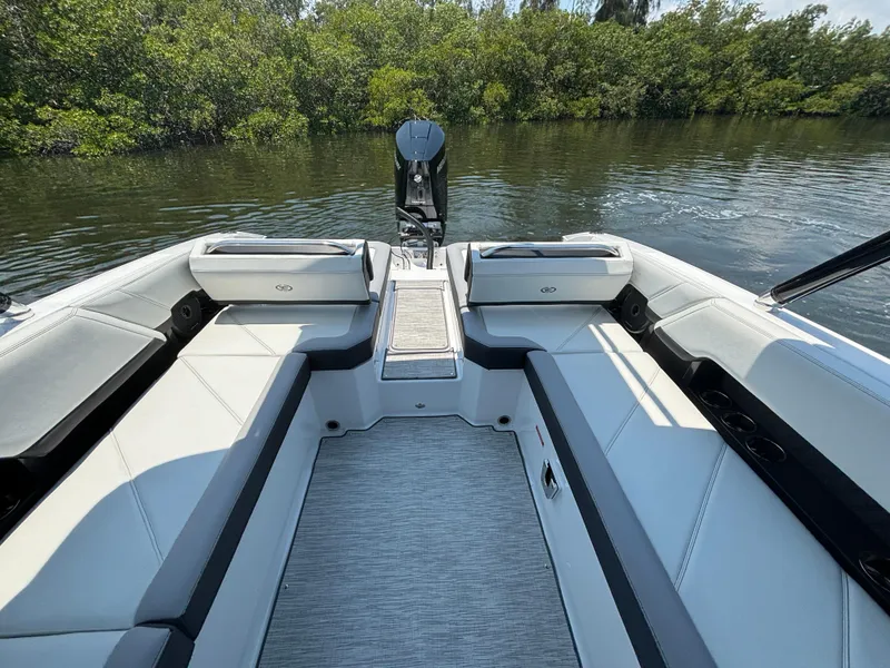 Slide: The Image of 2024 Cobalt R8 Outboard boat interior with spacious seating and scenic water view. - 7