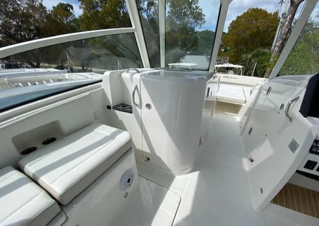 Slide: The Image of 2024 World Cat 325 DC boat interior with white seating and modern design. - 10