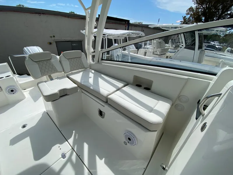 Slide: The Image of 2024 World Cat 325 DC boat interior with white cushioned seating. - 11