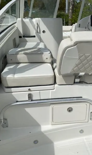 Slide: The Image of 2024 World Cat 325 DC boat interior with white cushioned seating. - 12