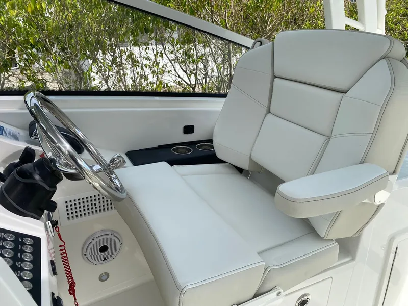 Slide: The Image of Captain's chair and helm of 2024 World Cat 325 DC boat. - 19
