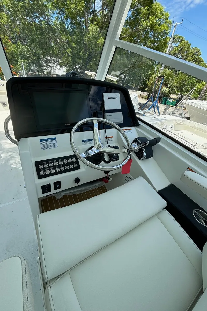 Slide: The Image of 2024 World Cat 325 DC helm station with modern controls and comfortable seating. - 20