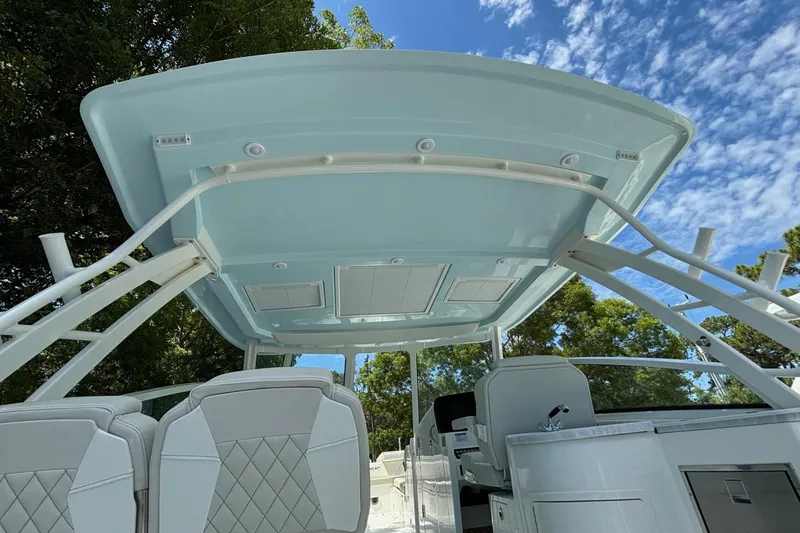 Slide: The Image of 2024 World Cat 325 DC boat interior with seating and canopy. - 22