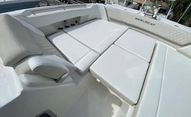 Slide: The Image of 2024 World Cat 325 DC boat with luxurious white seating and spacious deck. - 29